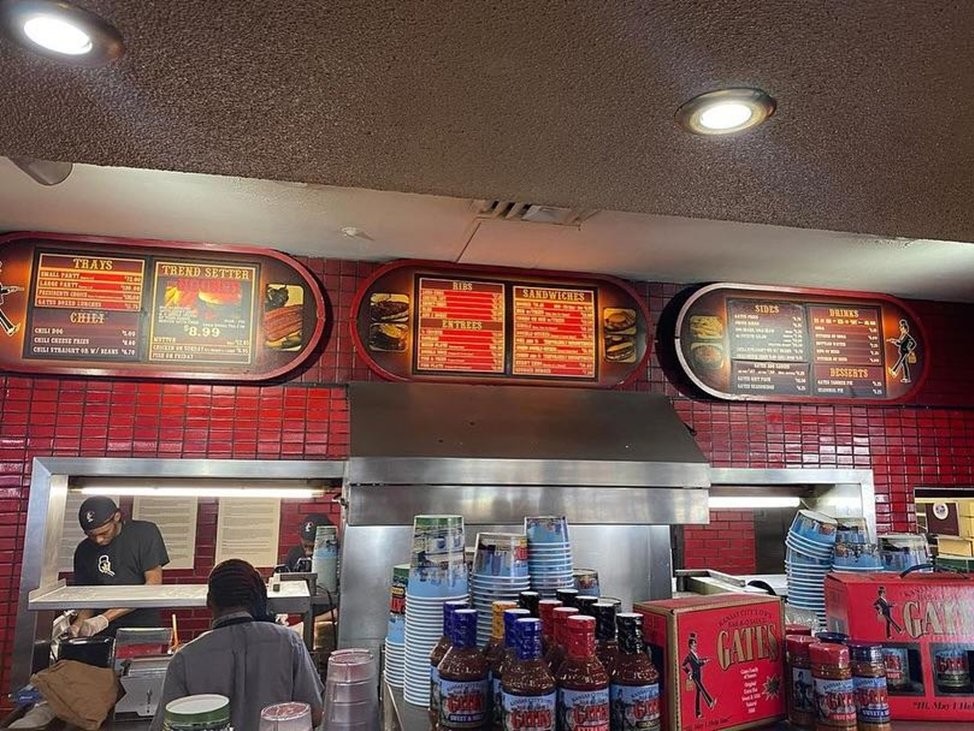 Front counter at Gates Bar-B-Q with large menu at the top
