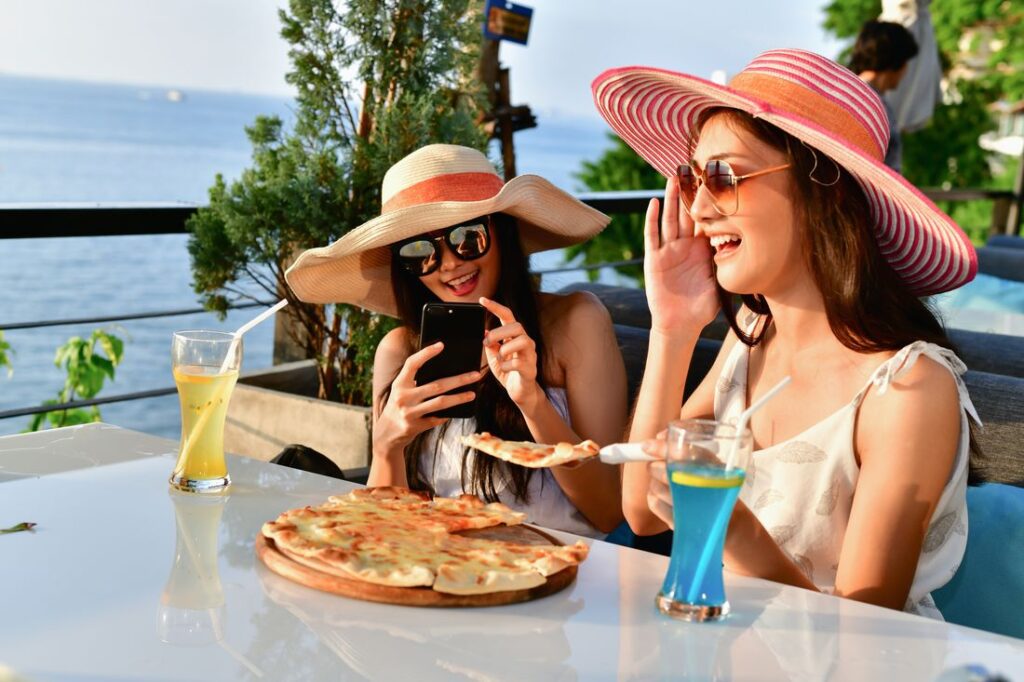 Two women eating at a seaside restaurant