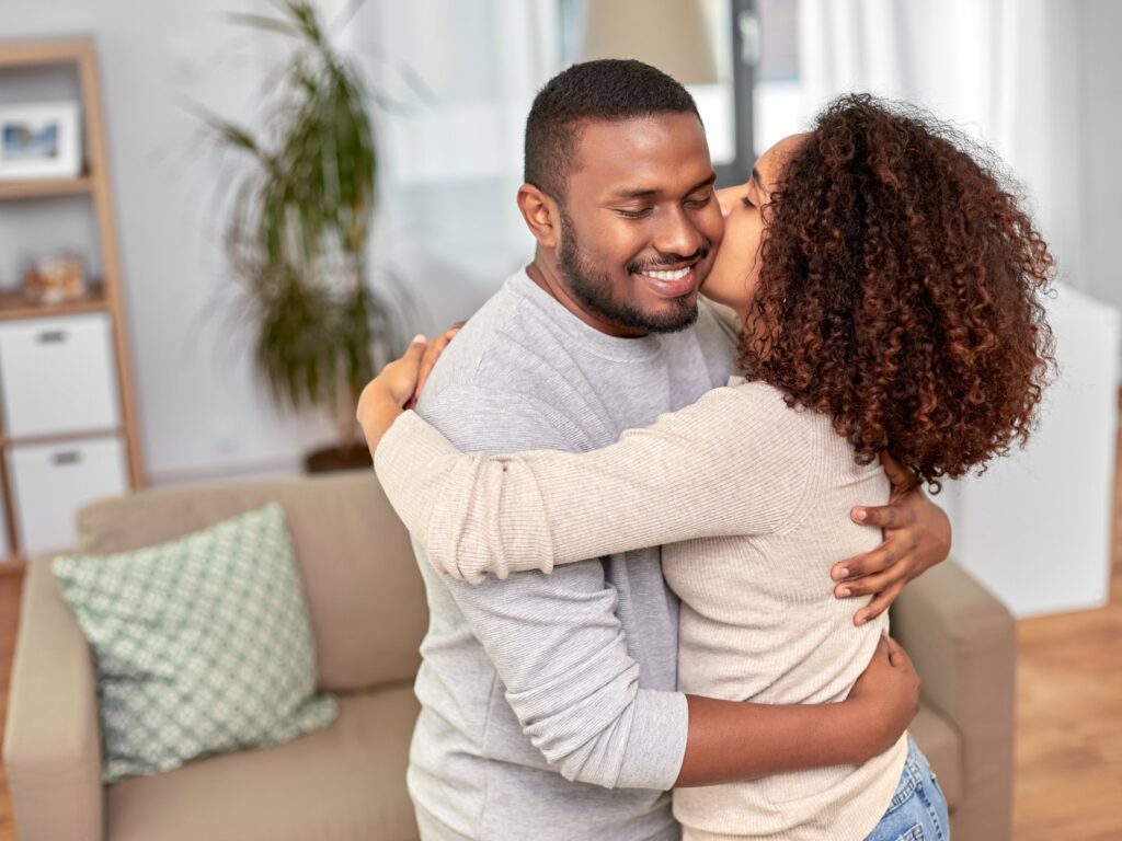 Happy couple smiling together at home