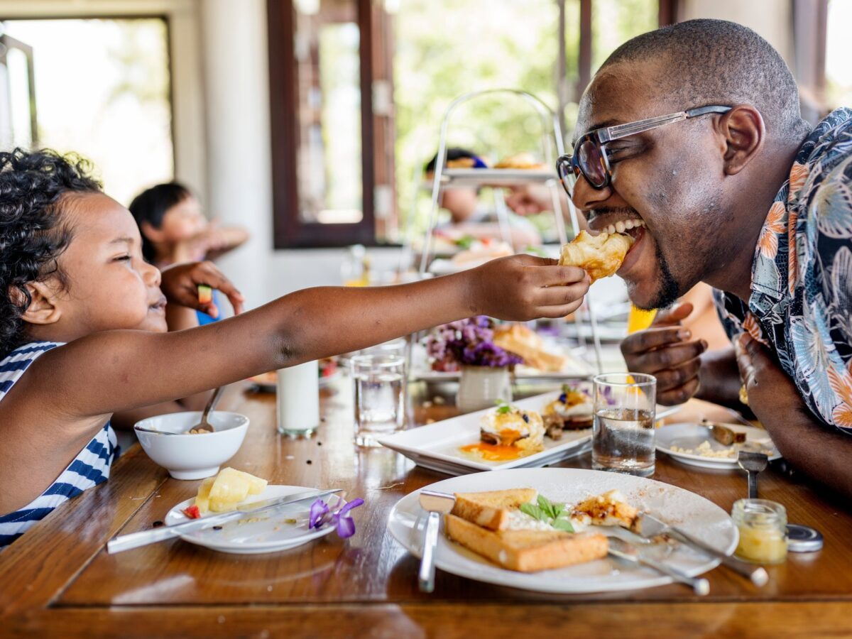 Father and child enjoying breakfast together in a restaurant