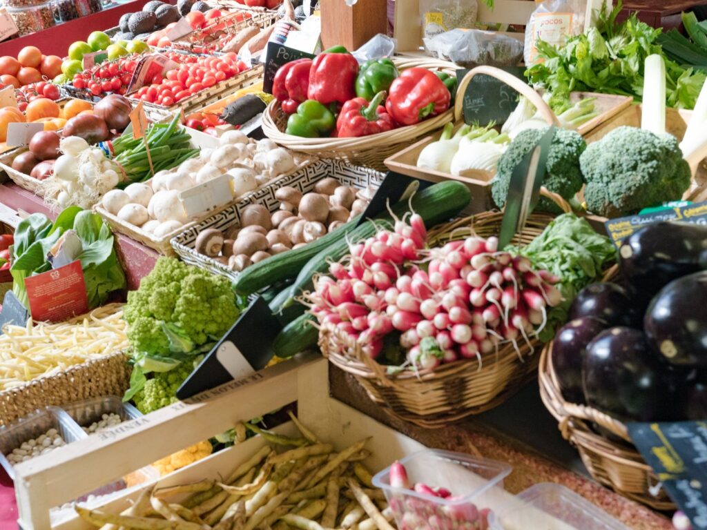 Vegetable stand in market hall with fresh organic vegetables