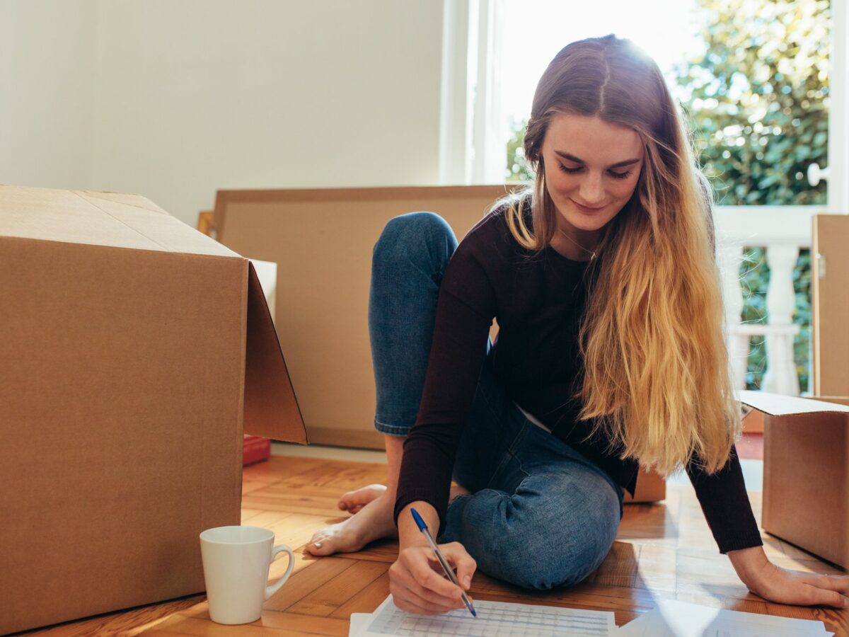 Woman making a list of items for packing