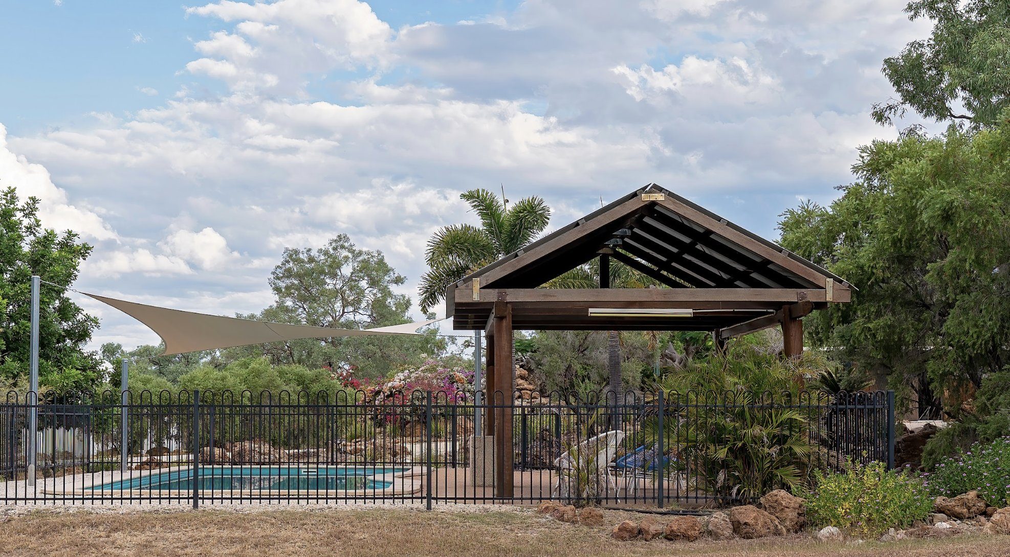 Nice fenced-in backyard pool on a summer day