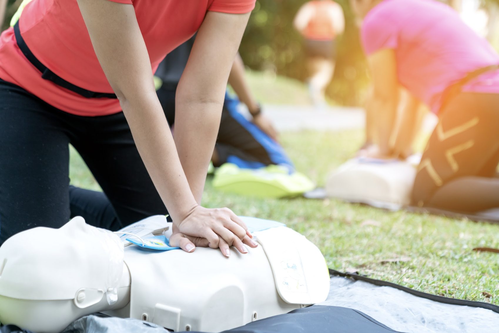 Group learning CPR together in a park
