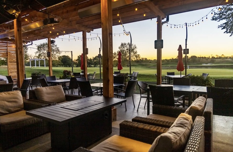 Outdoor patio dining at The Nest Bar & Grill at sunset.