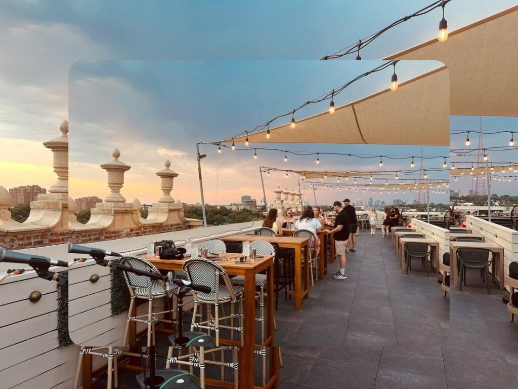 Beautiful outdoor rooftop patio of Blanc Champagne Bar at sunset.