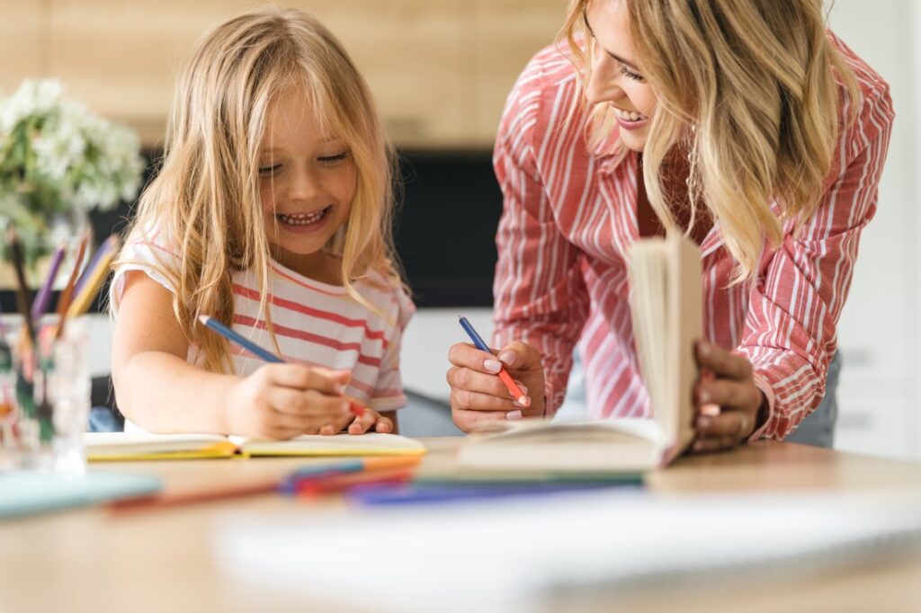 Mother and daughter drawing and smiling